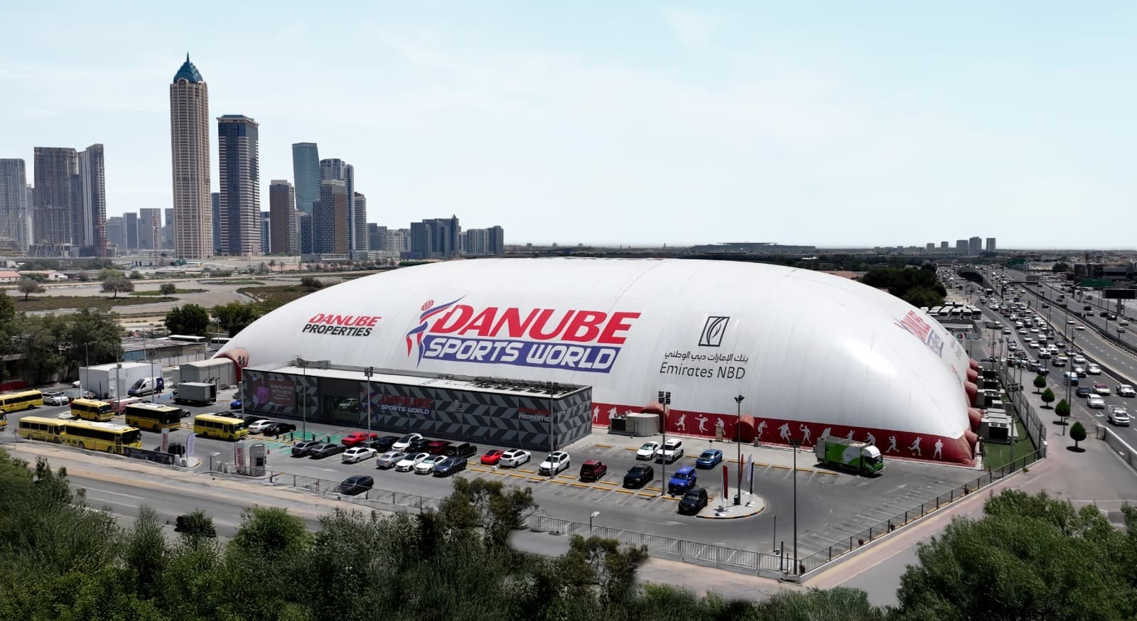 A large, modern sports stadium with large screens.